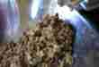 Grinding ingredients for frozen fish food.