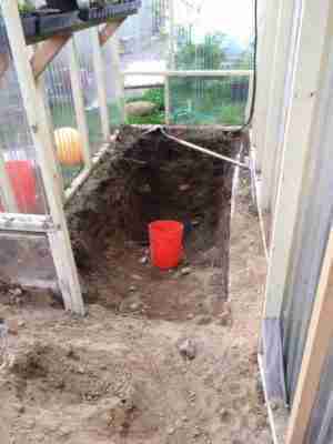 Digging a thermal collector pit.